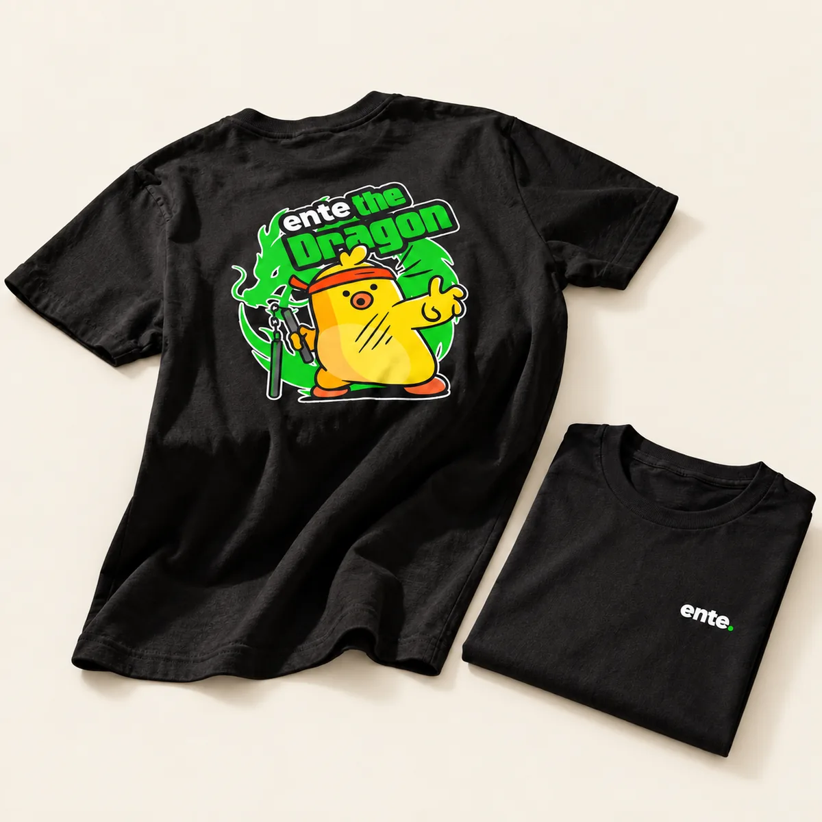Black tee with the Ente the Dragon duck on the back, folded next to the front