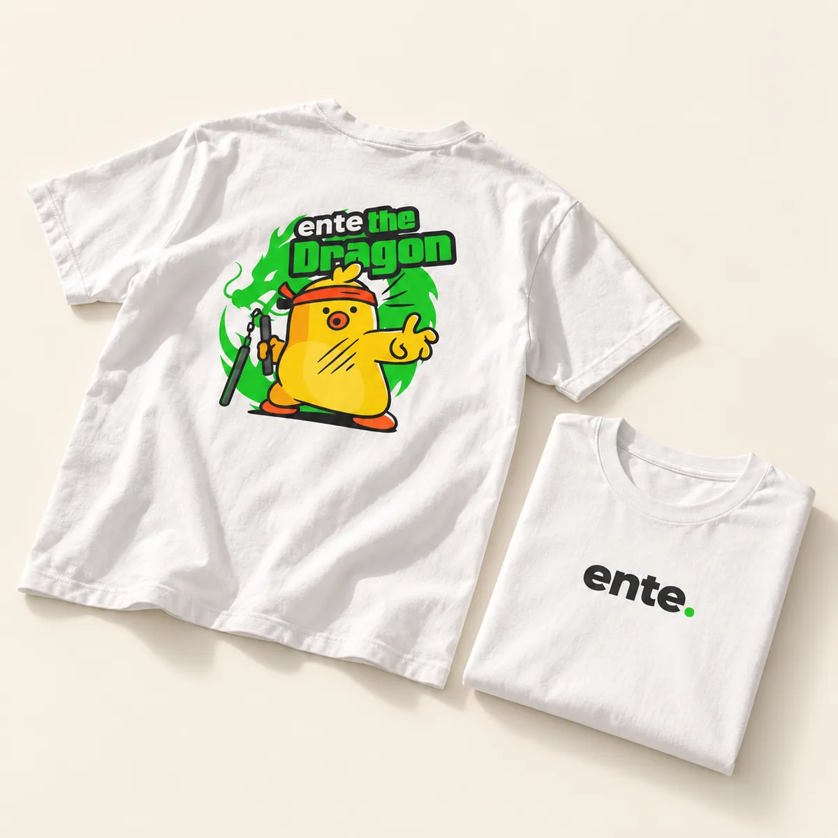 White tee with the Ente the Dragon duck on the back, folded next to the front